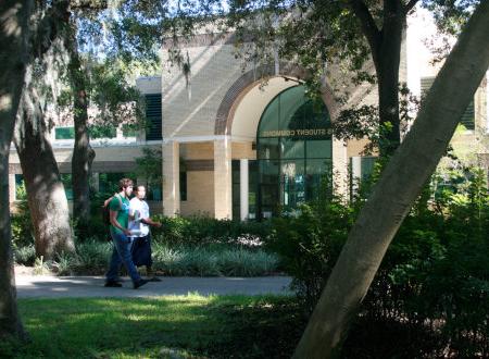 Two students walking in front of Davis Student Commons